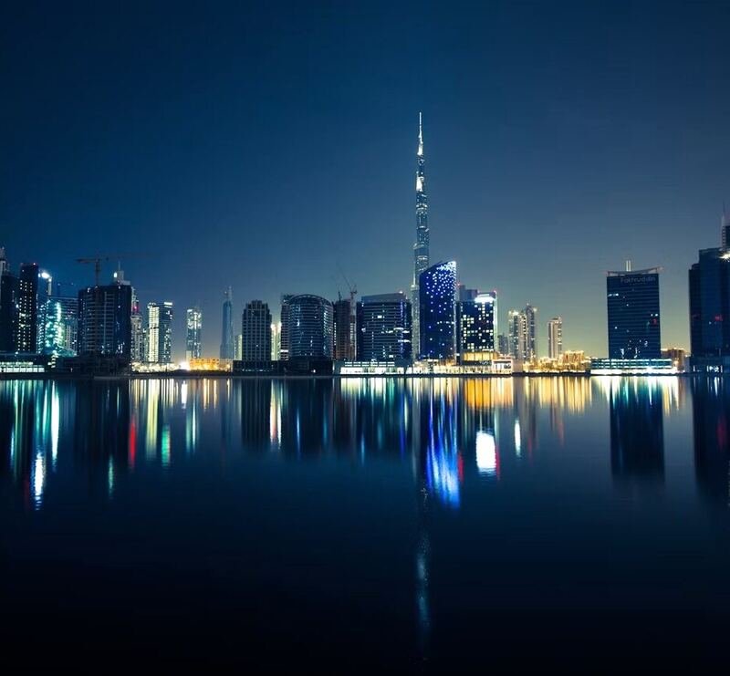 Dubai skyline reflected in still water at night (illustrative photo) – not a photo of Meydan