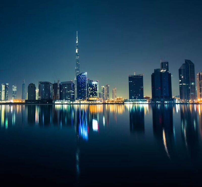 Dubai skyline reflected in still water at night (illustrative photo) – not a photo of Al Barsha