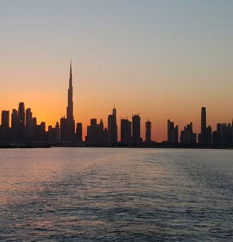 Dubai skyline silhouette across the water at sunset (illustrative photo) – not a photo of Jumeirah Beach Residence