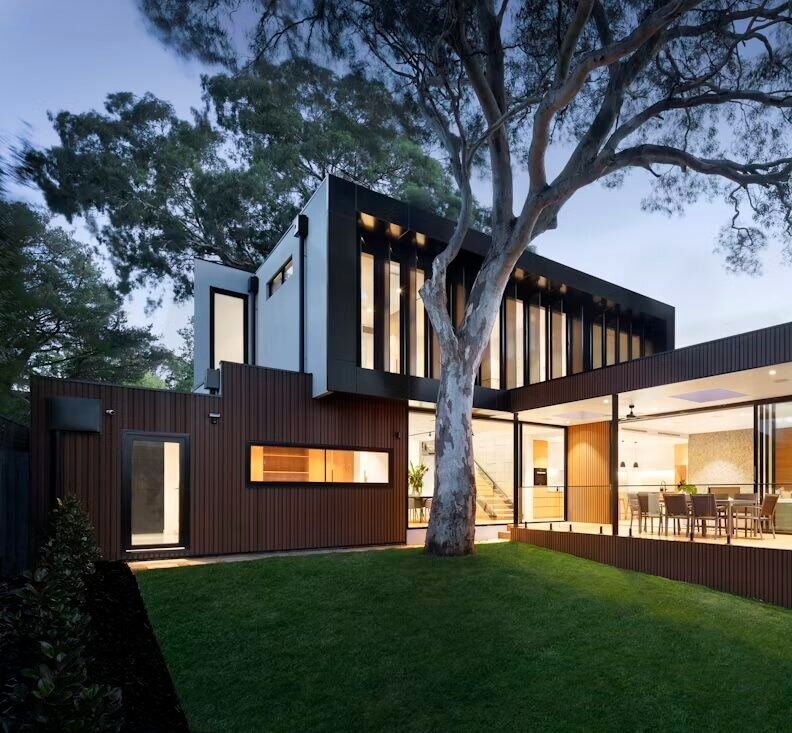 Contemporary villa exterior with lawn at dusk (illustrative photo) – not a photo of The Lakes